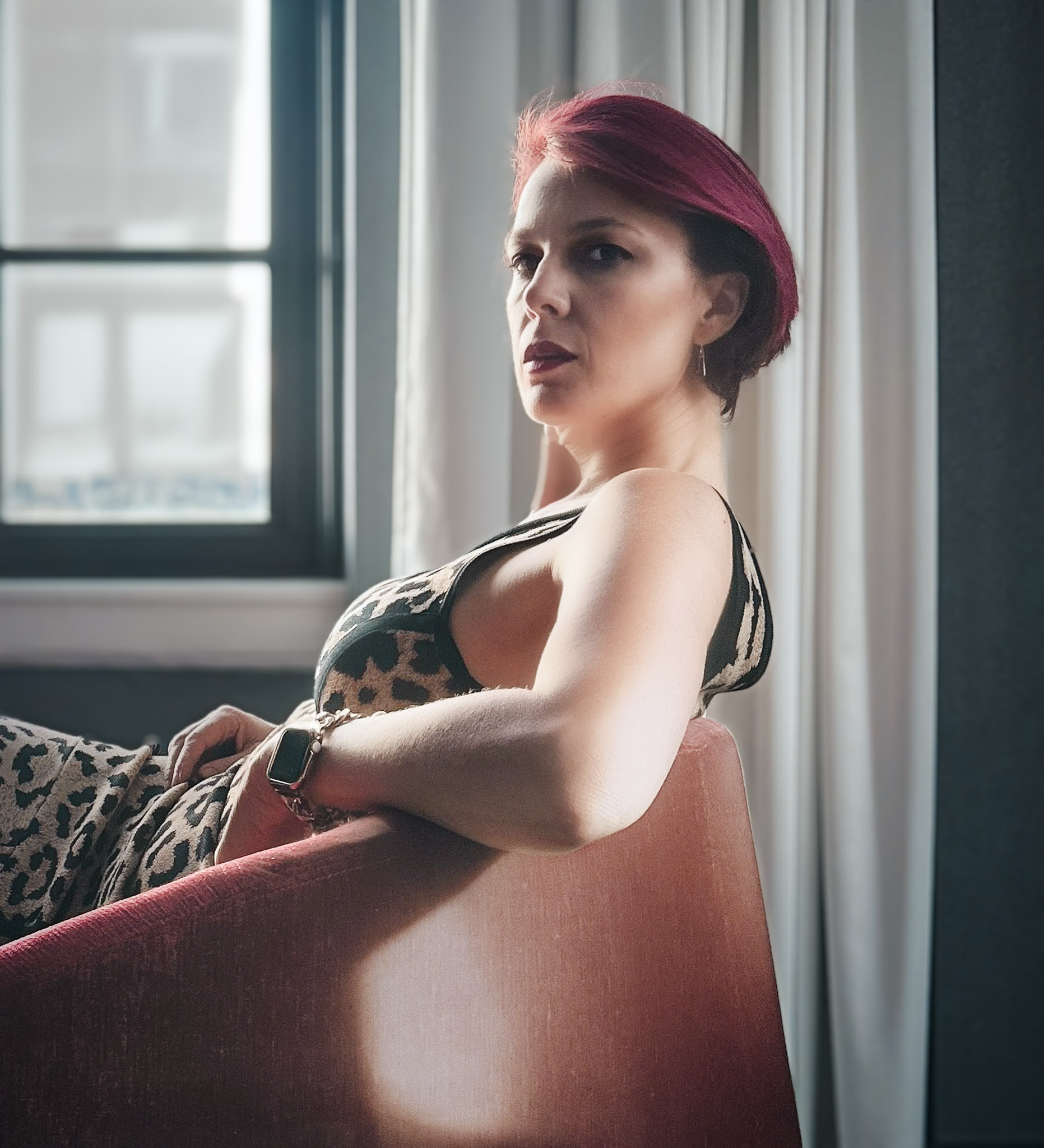 Viktoria Sway seated by a Manhattan window, looking over her shoulder